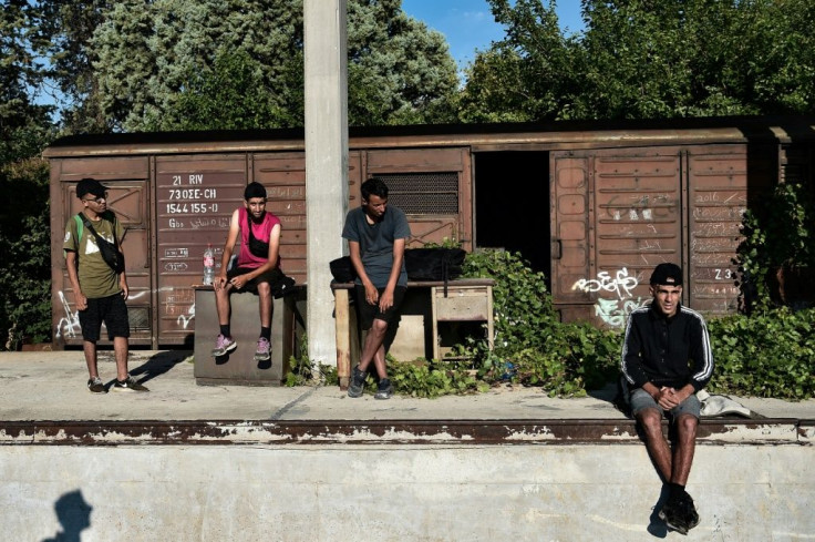 Migrants sleep in disused railway wagons and wait for the chance to hitch a ride on a train