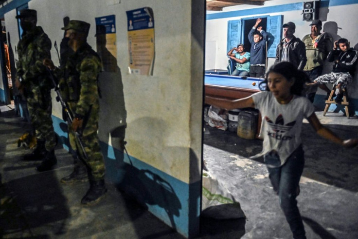 Colombian soldiers guard and area where former FARC rebels live with their families in Mutata, in the state of Antioquia