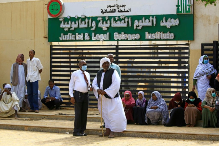 Sudanese gather outside the court where Bashir was tried. He could face the death penalty if convicted over his 1989 coup against the democratically elected government of prime minister Sadek al-Mahdi