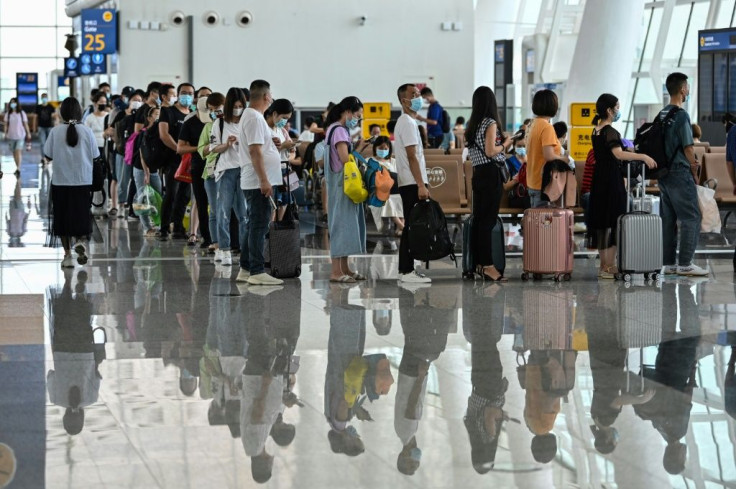 Passengers wearing facemasks at Tianhe Airport in Wuhan. China says all new arrivals will have to prove they don't have coronavirus before boarding incoming flights