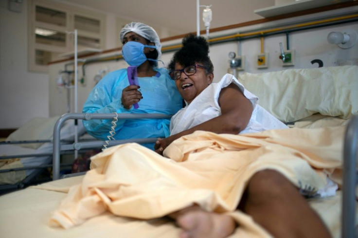 Claudia, a nurse at the Pedro Ernesto University Hospital post-COVID-19 care unit in Rio de Janeiro, takes care of a patient