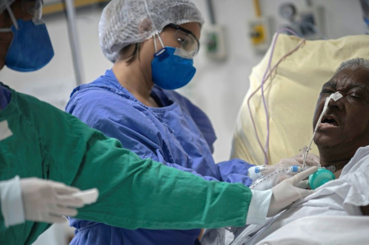Staff check on Elenice da Silva's tracheotomy in the post-COVID-19 care unit