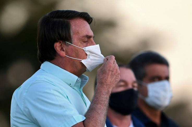 Brazilian President Jair Bolsonaro gestures as he speaks to supporters outside Alvorada Palace in Brasilia
