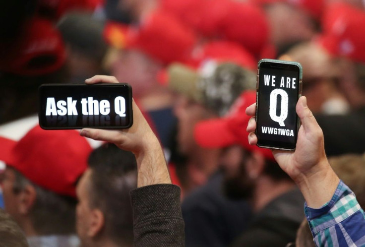 Supporters of President Donald Trump hold up their phones with messages referring to the QAnon conspiracy theory at a campaign rally at Las Vegas Convention Center on February 21, 2020 in Las Vegas, Nevada. The upcoming Nevada Democratic presidential cauc