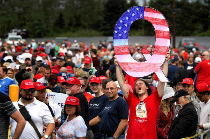David Reinert holds up a large "Q" sign while awaiting the arrival of US President Donald Trump at a 2018 "Make America Great Again" rally  in Wilkes Barre, Pennsylvania