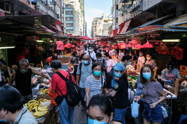 People shop for fruits and vegetables at a street market in Hong Kong