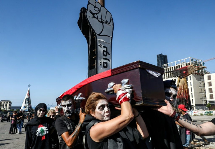 In this file photo taken on June 13, 2020, Lebanese anti-government protesters in Beirut take part in a symbolic funeral for the country amid a deepening economic crisis