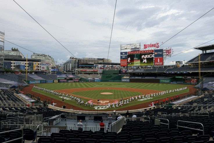 The New York Yankees and the Washington Nationals kneel in a moment of silence for Black Lives Matter at Major League Baseball's season-opening game