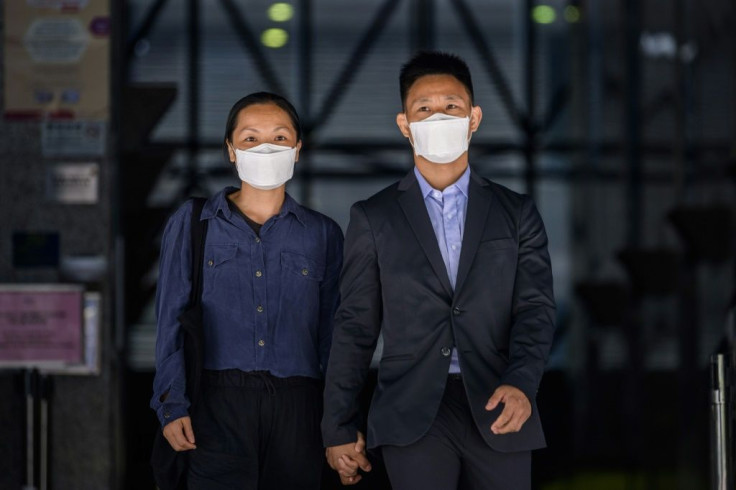 Elaine To, 41, and Henry Tong, 39, leave the District Court in Hong Kong after being found not guilty of rioting during last year's pro-democracy protests