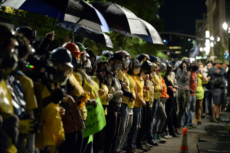 Mothers form a human chain during a protest in Portland