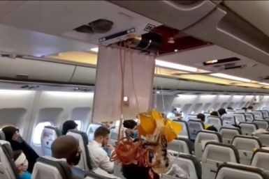 An oxygen mask dangles in the cabin of an Iranian passenger plane after it was intercepted by US jets while flying over Syria