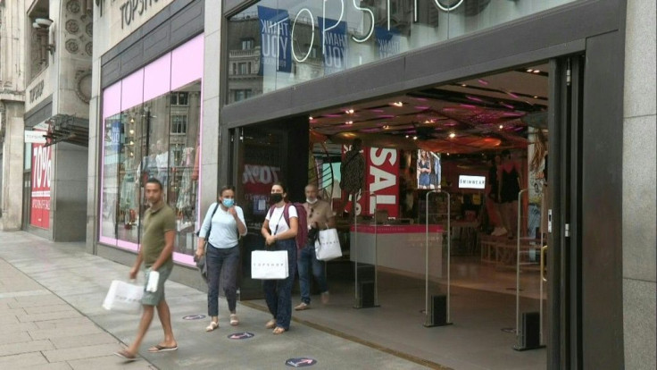 People walk the busy streets of Oxford Street in central London as it becomes compulsory to wear masks in shops