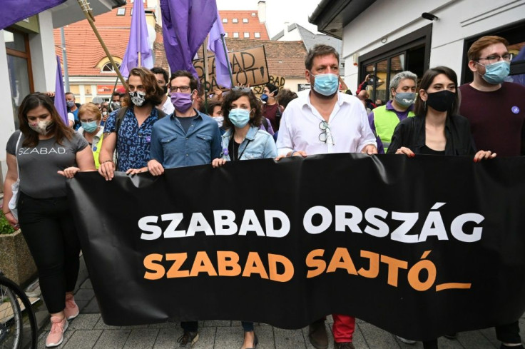 Protesters hold a banner with the slogan "Free country, free press" after the editor of an independent news site was sacked prompting a mass staff walk out