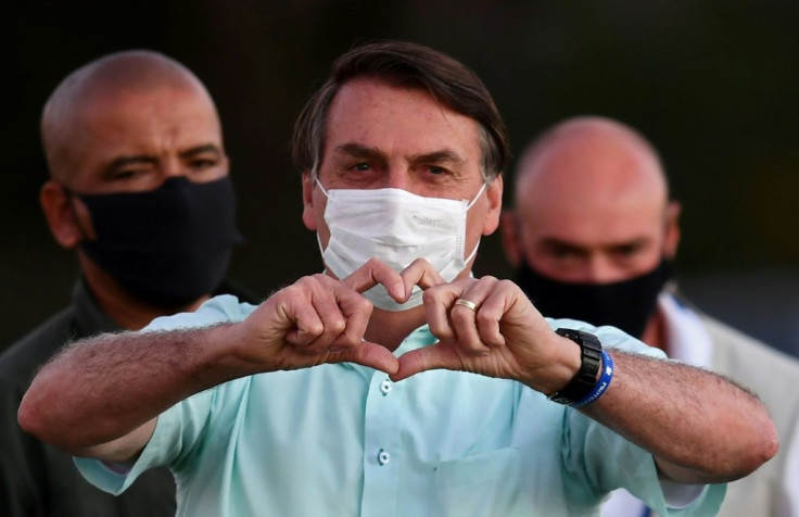 Brazilian President Jair Bolsonaro greets supporters in the garden of the Alvorada Palace in Brasilia, on July 22, 2020