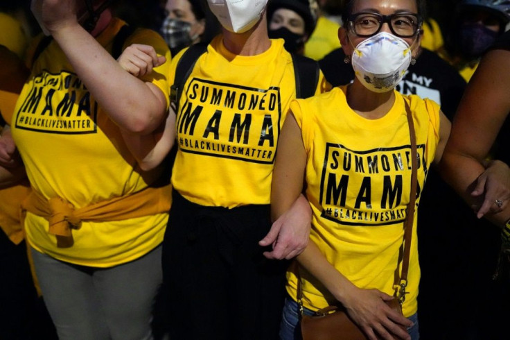 PORTLAND, OR - JULY 21: Members of the "Wall of Moms", a group of protesters who form non-violent human barriers between police and the crowd, stand arm in arm during a protest at the Mark O. Hatfield U.S. Courthouse on July 21, 2020 in Portland, Oregon.