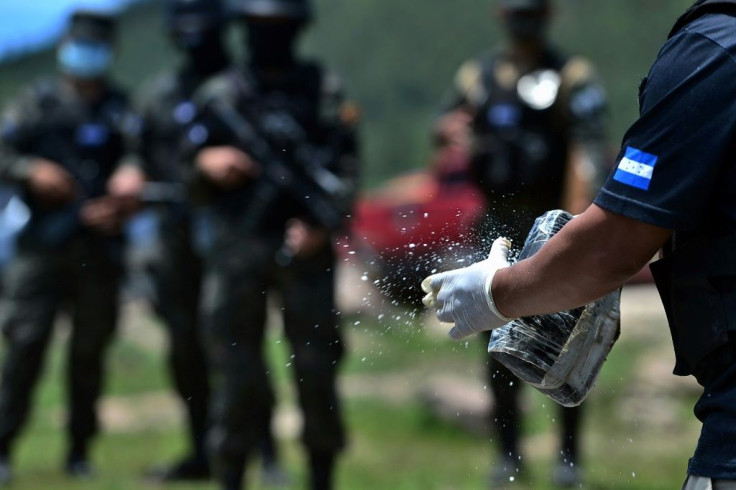 Members of Honduras's criminal investigation agency prepare to burn 250,000 kilograms of cocaine seized during the month of May 2020