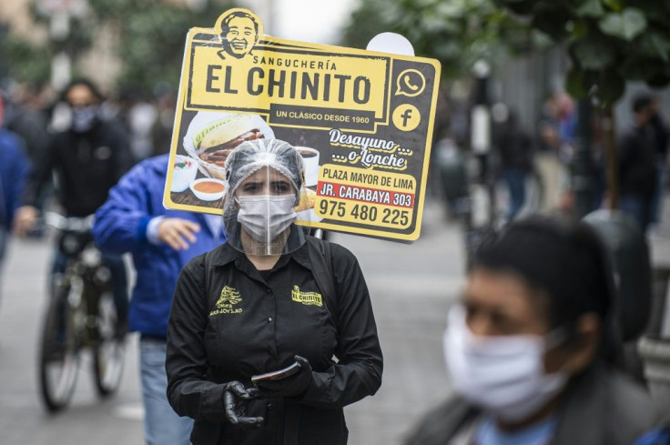 A woman promotes a sandwich restaurant in downtown Lima mandatory national quarantine due to the COVID-19 coronavirus pandemic
