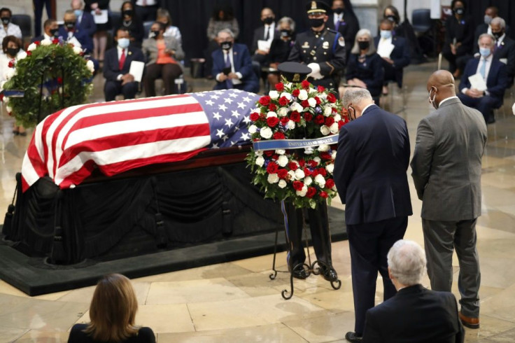 Senate Minority Leader Chuck Schumer (L) and Republican Senator Tim Scott of South Carolina (R) stand at the casket of the late Rep. John Lewis