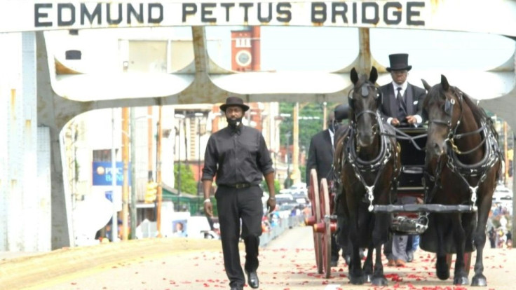 In a deeply symbolic tribute, a lone caisson drawn by two black horses on Sunday slowly carried the body of John Lewis across the Edmund Pettus Bridge, where in 1965 a policeman had fractured his skull during a protest that helped forge his reputation as 