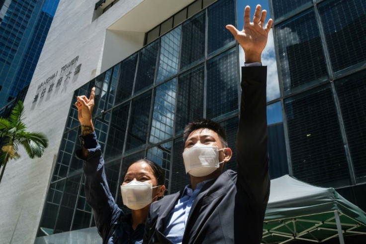 To (left) and Tong celebrate outside court after their acquittal