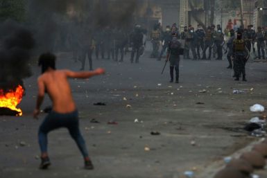 Iraqi demonstrators clash with security forces in al-Tayaran square in central Baghdad on Monday during ongoing anti-government protest over poor public services