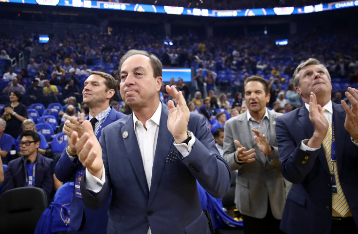 Golden State Warriors owners Joe Lacob and Peter Guber stand with team president and COO Rick Welts