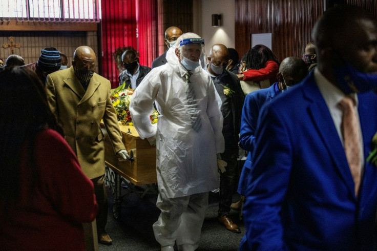An undertaker wears a protective suit for a funeral in Johannesburg. South Africa has the highest numbers of diagnosed infections in Africa