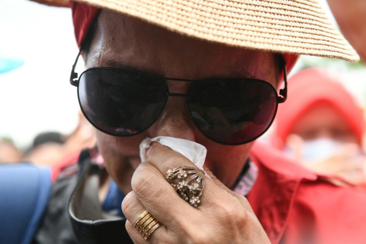A supporter of Malaysia's former prime minister Najib Razak weeps after he was found guilty