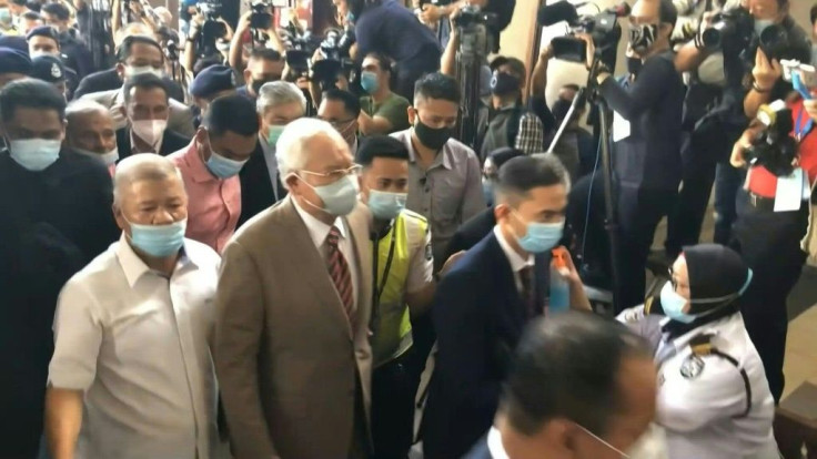 Najib Razak arrives at court in Kuala Lumpur where he will face the verdict in his first corruption trial following a long-running case probing the former prime minister's role in the multi-billion-dollar 1MDB scandal.