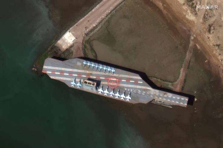 This handout satellite image obtained courtesy of  Maxar Technologies shows a mockup aircraft carrier being prepared in the Iranian port of Bandar Abbas on February 15