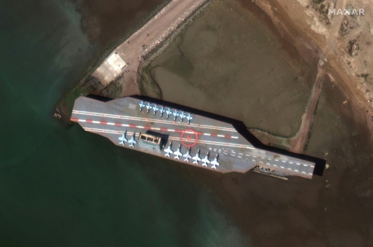This handout satellite image obtained courtesy of Maxar Technologies shows a mockup aircraft carrier being prepared in the Iranian port of Bandar Abbas on February 15