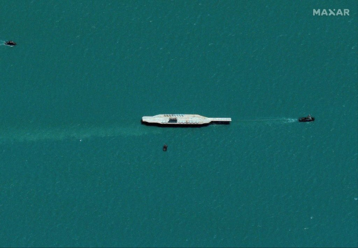 This handout image shows the mockup carrier being towed out into the Strait of Hormuz on July 25 in readiness for Tuesday's Iranian exercises