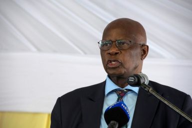 Zimbabwe's ruling party spokesman Patrick Chinamasa, seen here in 2017, has called the US ambassador a "thug" and alleged a plot to back protesters