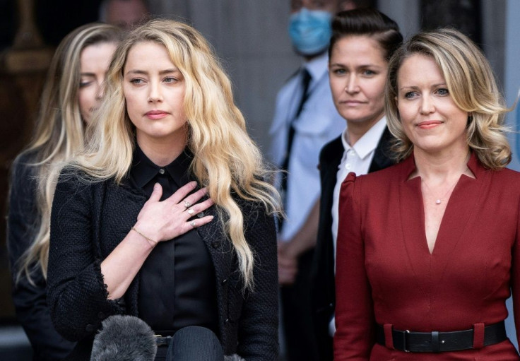 'It has been incredibly painful to relive the breakup of my relationship,' Amber Heard told reporters outside court