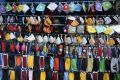 A vendor arranges facemasks to sell on a roadside in Hyderabad, India