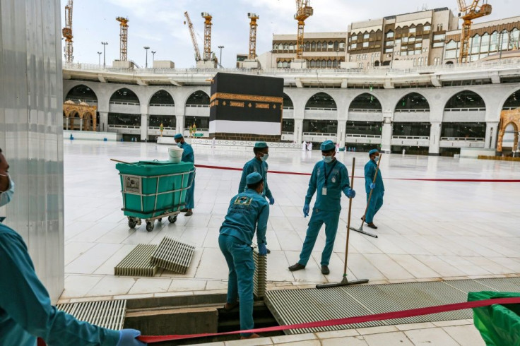 Workers clean the area around the Kaaba, the structure at the centre of the Grand Mosque towards which Muslims around the world pray