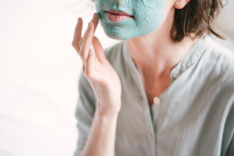 woman-applying-face-mask-3059403