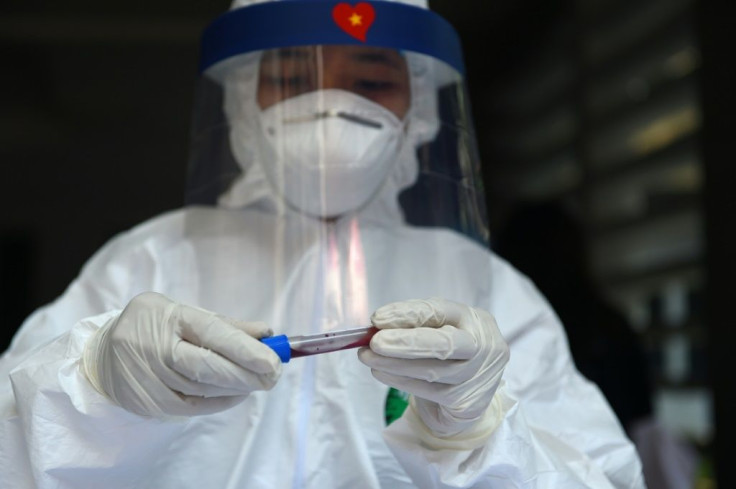 Medical workers took blood samples and mouth swabs at a makeshift testing centre in Hanoi