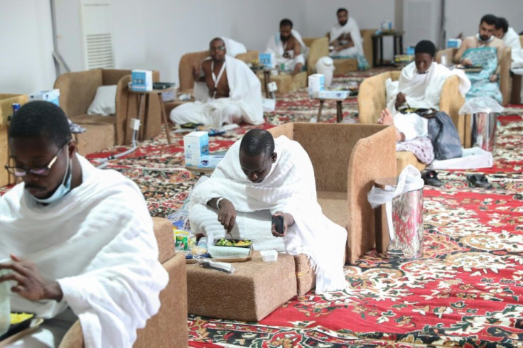 A handout picture provided by the Saudi Ministry of Media shows Muslim pilgrims resting and eating inside a tent in Mina near the holy city of Mecca during the annual Hajj pilgrimage
