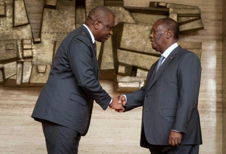 Ivory Coast's newly appointed Prime Minister Hamed Bakayoko (left) shakes President Alassane Ouattara