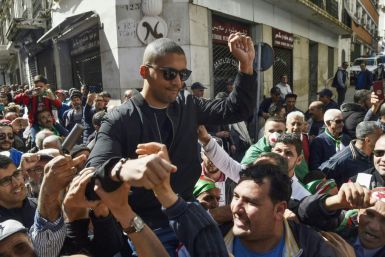 Algerian protesters carry journalist Khaled Drareni on their shoulders on March 6, 2020, the day before he was arrested while covering an anti-government protest, accused of "inciting an unarmed gathering"