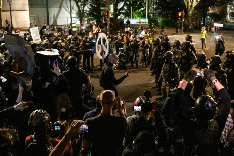 Demonstrators confront law enforcement during a protest against racial injustice, police brutality and the deployment of federal troops to US cities on July 29, 2020 in Portland, Oregon