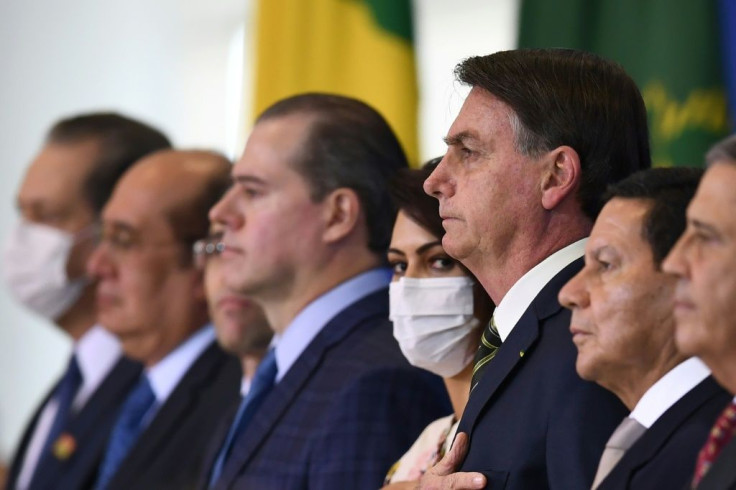 Brazilian President Jair Bolsonaro (C), his wife Michelle (C-L) and his Vice-President Hamilton Mourao (C-R) attend the inauguration ceremony of Andre Mendonca as new Justice Minister in Brasilia in April