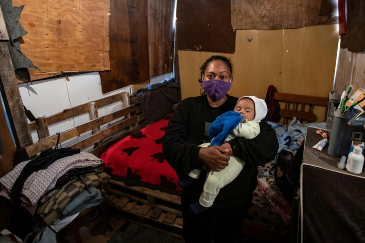 Resident of the Jardim Julieta favela, Priscila Tomas da Silva poses with her son Igor at their home in the outskirts of Sao Paulo, Brazil, on July 15, 2020