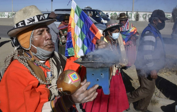 Bolivian peasants and indigenous people take part in a protest against a second postponement of the country's general election in the city of El Alto on July 28, 2020