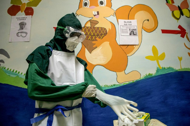 A nurse dons protective gear before entering a coronavirus isolation ward in the Saint Petros Hospital in Addis