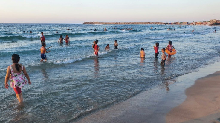 Libyans cool down at the beach amid electricity cuts and soaring temperatures in the capital Tripoli