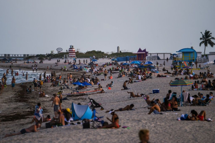 People relax on the beach in Miami Beach, Florida -- a state seeing record numbers of COVID-19 deaths