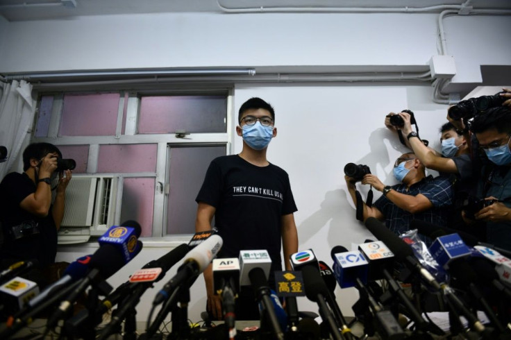 Hong Kong pro-democracy activist Joshua Wong (C) says 'resistance will continue'