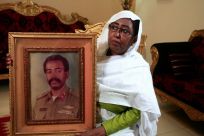 Awatef Mirghani holds a portrait of her brother Esmat, a Sudanese officer who was executed following the 1990 coup attempt